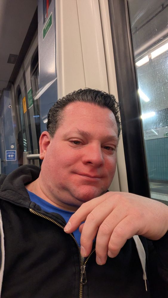 Me smiling into the camera. Sitting in a train