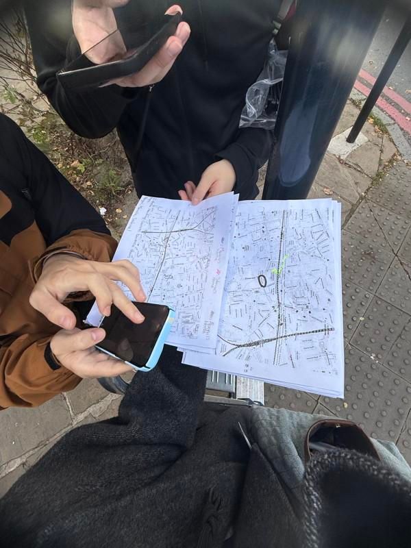 UCL Chemistry students looking at their maps to determine where to site their tubes after getting instruction from the class. 