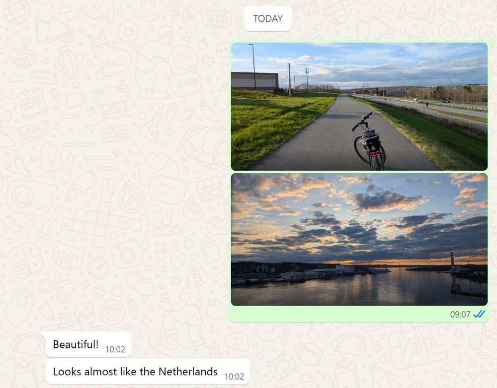Screenshot of a Whatsapp conversation in which Ben has sent a friend two photos, one of a bike on a multi-use path next to Highway 111, and another of Halifax Harbour under a beautiful dusk sky. The friend responded: "Beautiful! Looks almost like the Netherlands."
