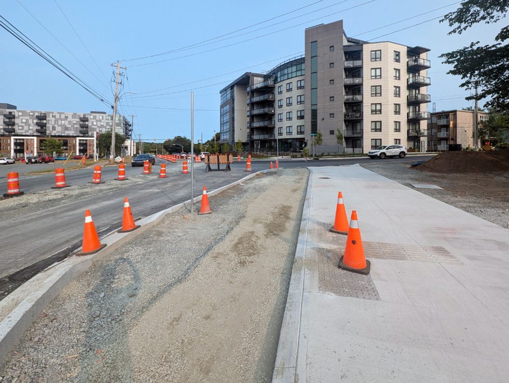Dutch Village Road just west of Westerwald Street. The sidewalk has been completed here, but the bike lane and roadway are still under construction and have yet to be paved.
