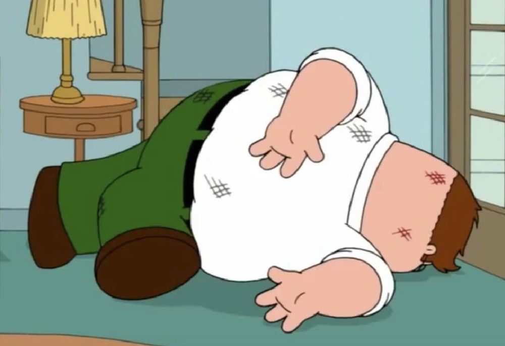 Peter griffin from family guy crumpled at the bottom of his stairs in the famous “family guy death pose”
