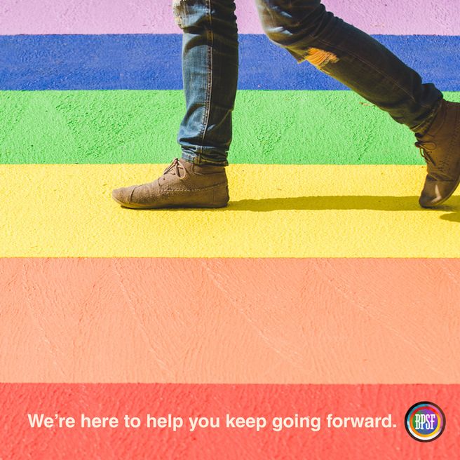 Image of someone walking across a rainbow crosswalk. Text reads "we're here to help you keep going forward."