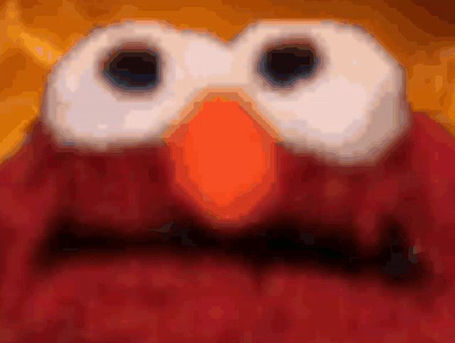 a close up of elmo 's face with a blurred background