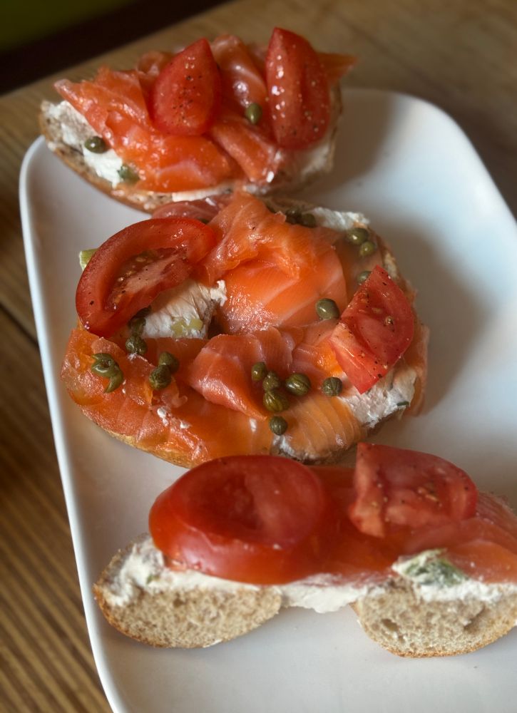 Lox salmon tomatoes tofu and capers on whole-wheat bagel 