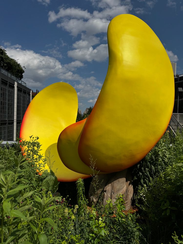 Sculpture that looks like pieces of giant peel, perhaps peach but more yellow 