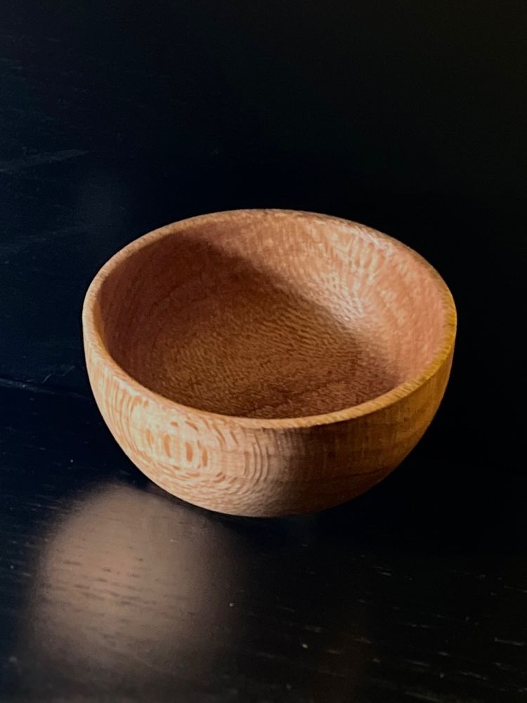 The inside of the little wooden bowl I made.
The photo was taken with a black background to show off the depth and contrast against the lighter color wood. 