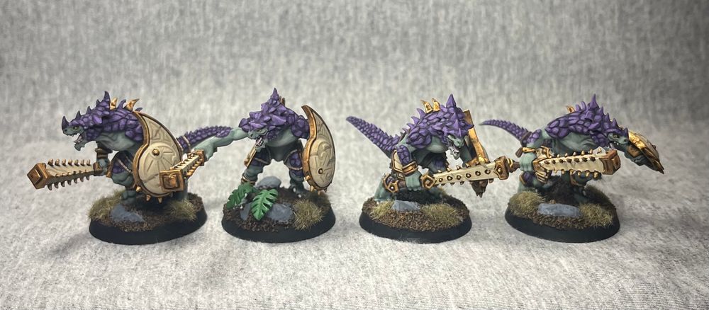 Painted Lizardman miniatures.