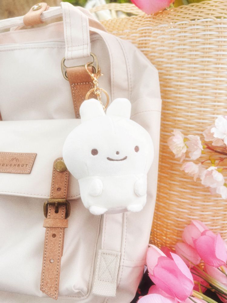 Image of a baby bun plush charm attached to a backpack.