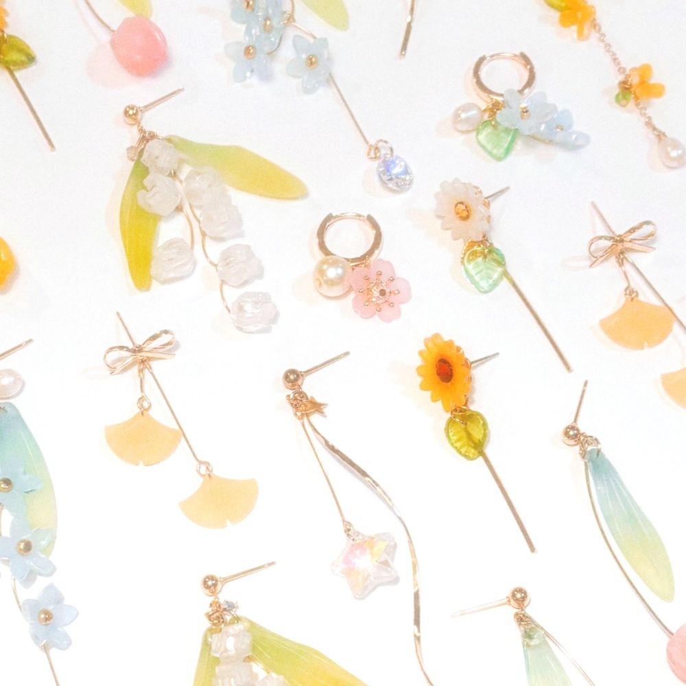 Image of a flat lay of floral earrings spread out.