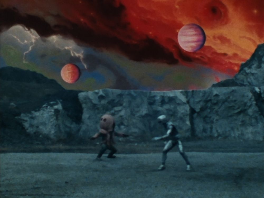 Gavan fight the monster, with two planets in the background