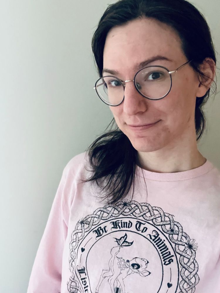 woman with dark hair wearing a pink black metal bambi fiadh productions shirt