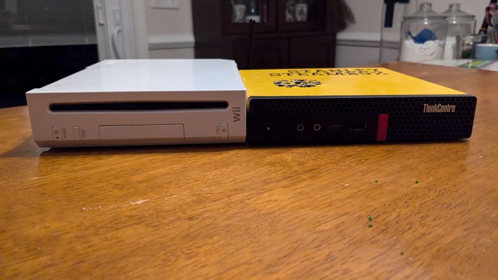 A console I call Stanley Steambox, built on a Lenovo thinkcentre workstation next to a Nintendo Wii. The Wii is taller, and Stanley is a little bit wider. 
