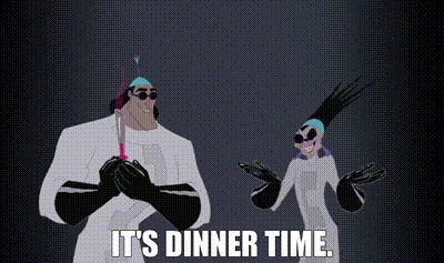 An animated gif image from the Disney movie The Emperor’s New Groove, depicting a scene in which the villain Yzma and her henchman Kronk, both dressed in the attire of Yzma’s secret and evil science lab, anticipate dinner, at which they plan to assassinate the emperor. Yzma throws her hands into the air and cries, in tones most evil, “It’s dinner time!”