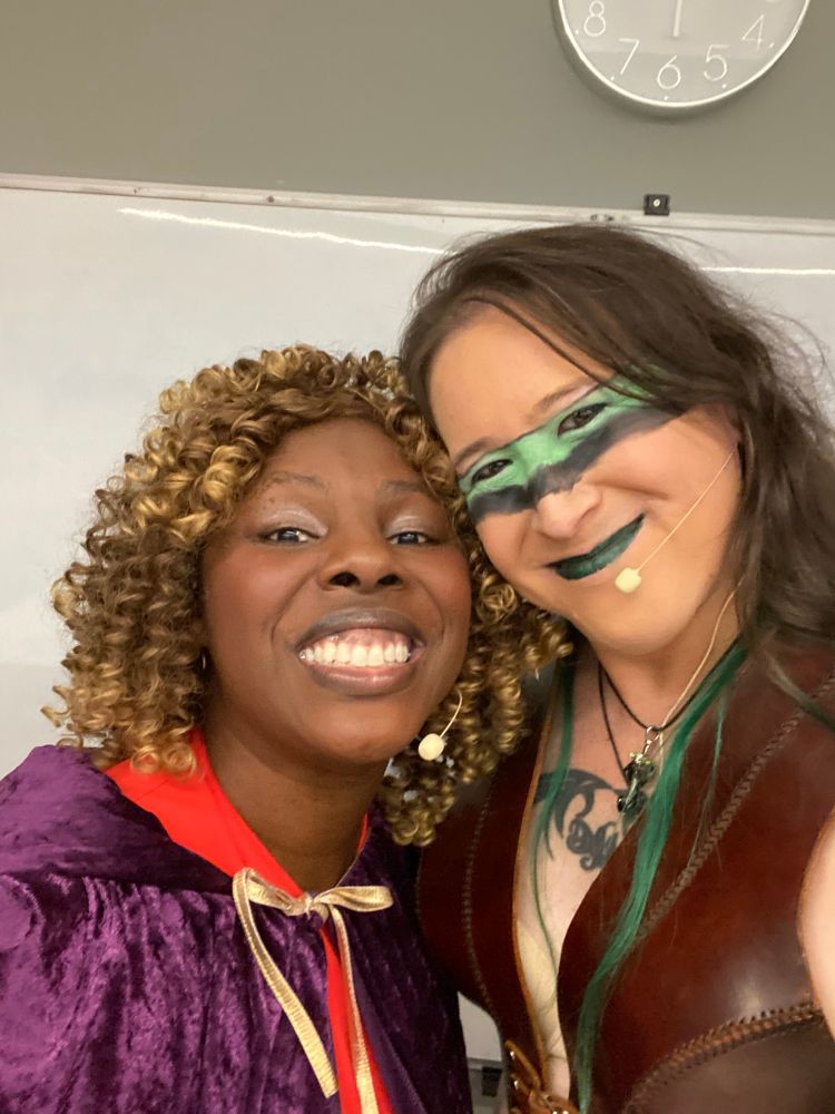 Hiromi smiles and hugs Abie Ekenezar, who is dressed in cleric robes