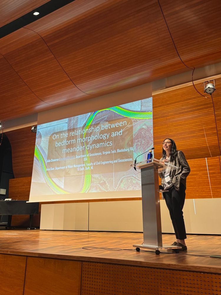 Julia Cisneros stands behind a podium introducing her talk at the conference. 