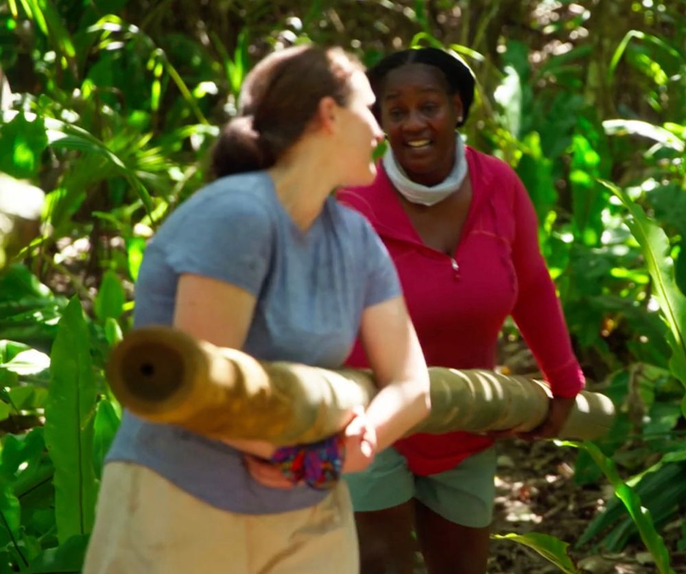 Lisa Holmes carries wood with queen mother Cirie Fields.