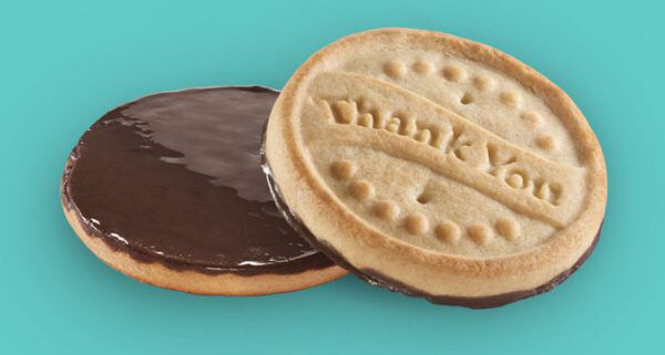 girl scout thanks a lot cookie. it’s a shortbread cookie with a layer of chocolate on the back. the obverse has thank you in a random language stamped on it