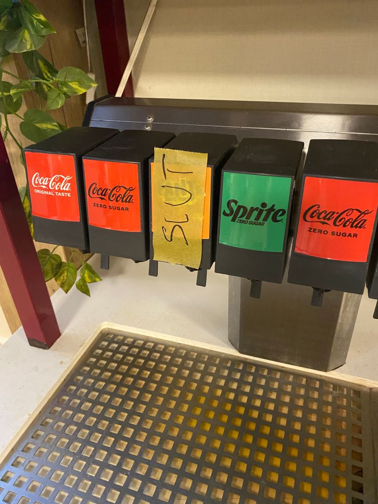 A dispenser machine for sodas is out of Fanta. That is signalled by a piece of paper taped on the sign with the Swedish word for “finished” which is “slut”