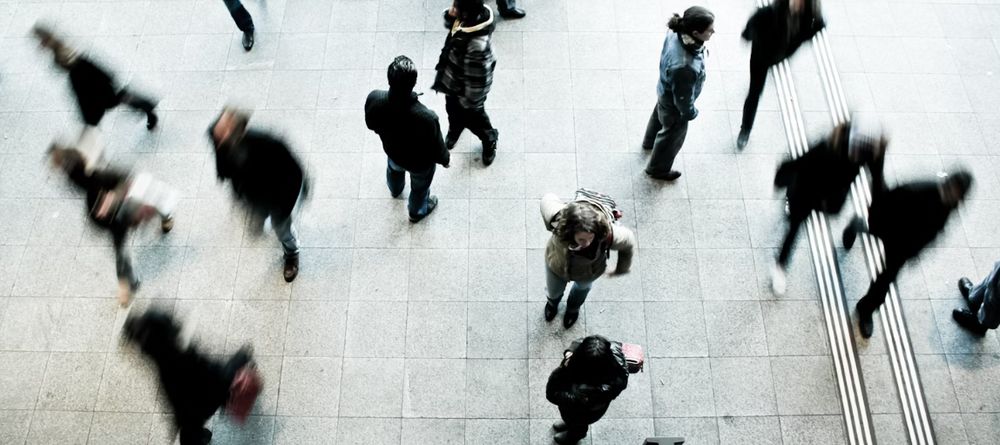 Photo from above of people walking around blurred