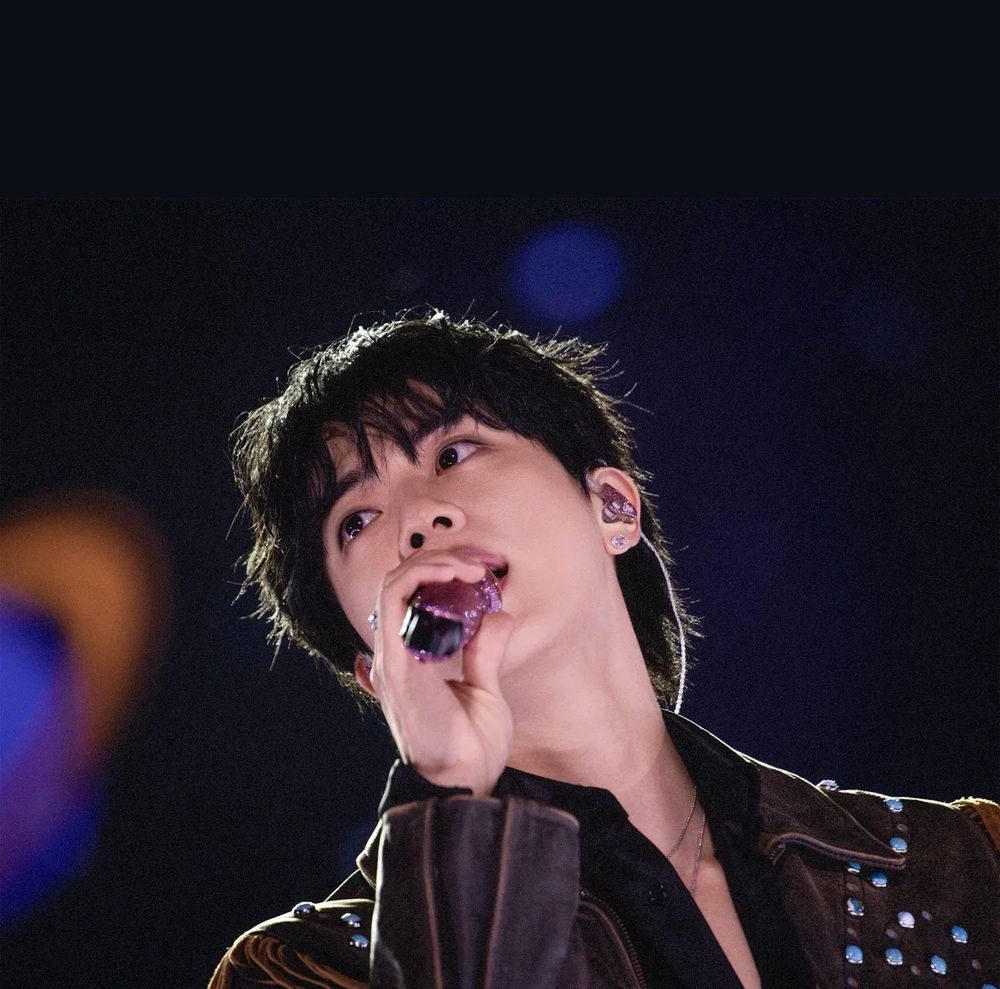 Seokjin mid-performance gazing at ARMY with misty eyes