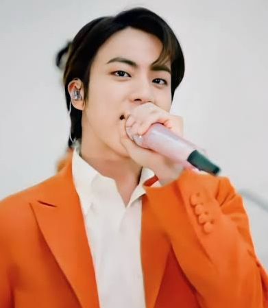 Seokjin in an orange suit