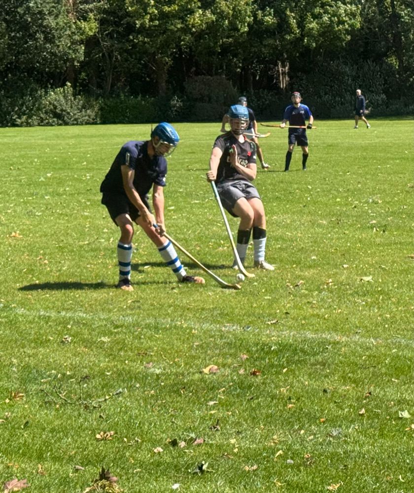 Picture of two players competing at shinty 