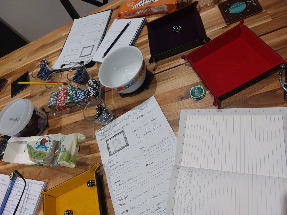 A table strewn with paper, dice, poker chips to act as XP and of course, popular Australian snack, TimTam