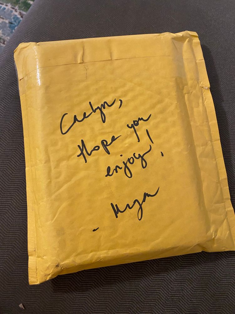 yellow jiffy envelope with message written on the back in black marker: Caelyn, hope you enjoy! —Megan