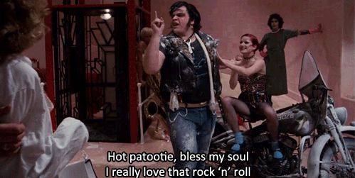 Meatloaf sings “Hot Patootie” standing next to a motorcycle.