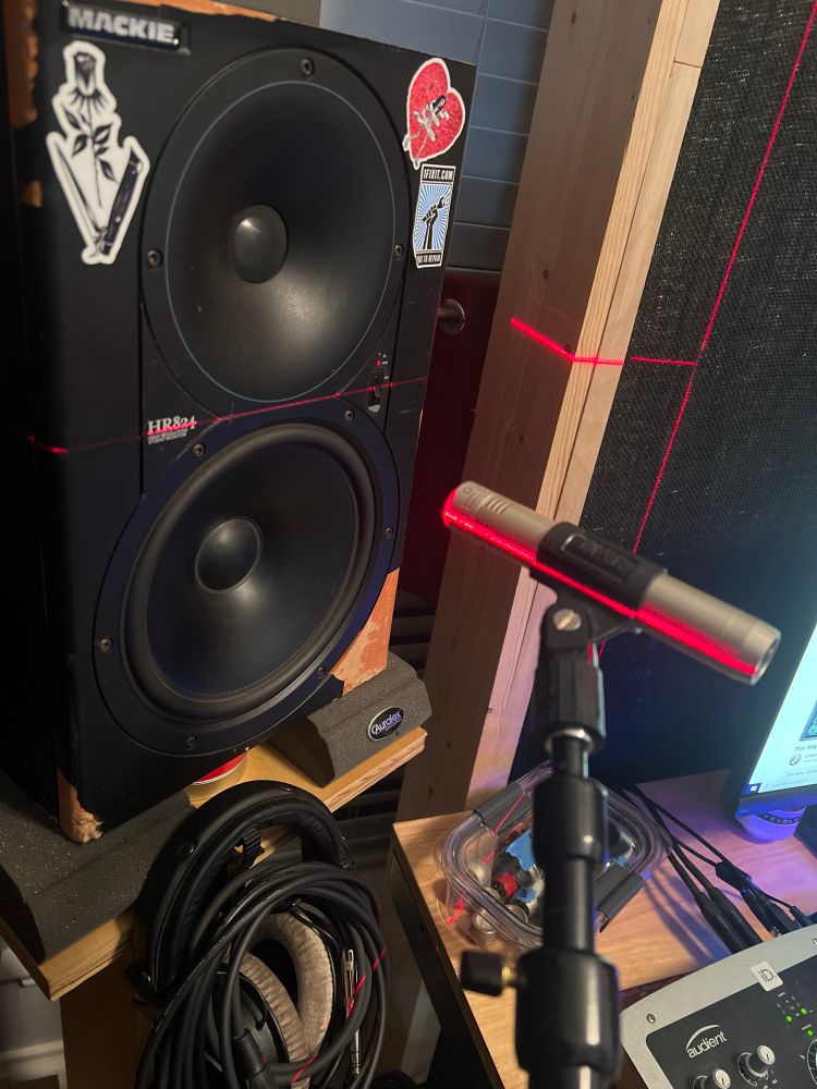 a microphone pointing at a studio monitor, with lasers guiding the position. the goal of this exercise is to try many different combinations of microphone body/circuit/capsule while changing as little else as possible. 

if done correctly, i should be able to see accurate data about variations in polar pattern, frequency response, noise, and other tonal characteristics.