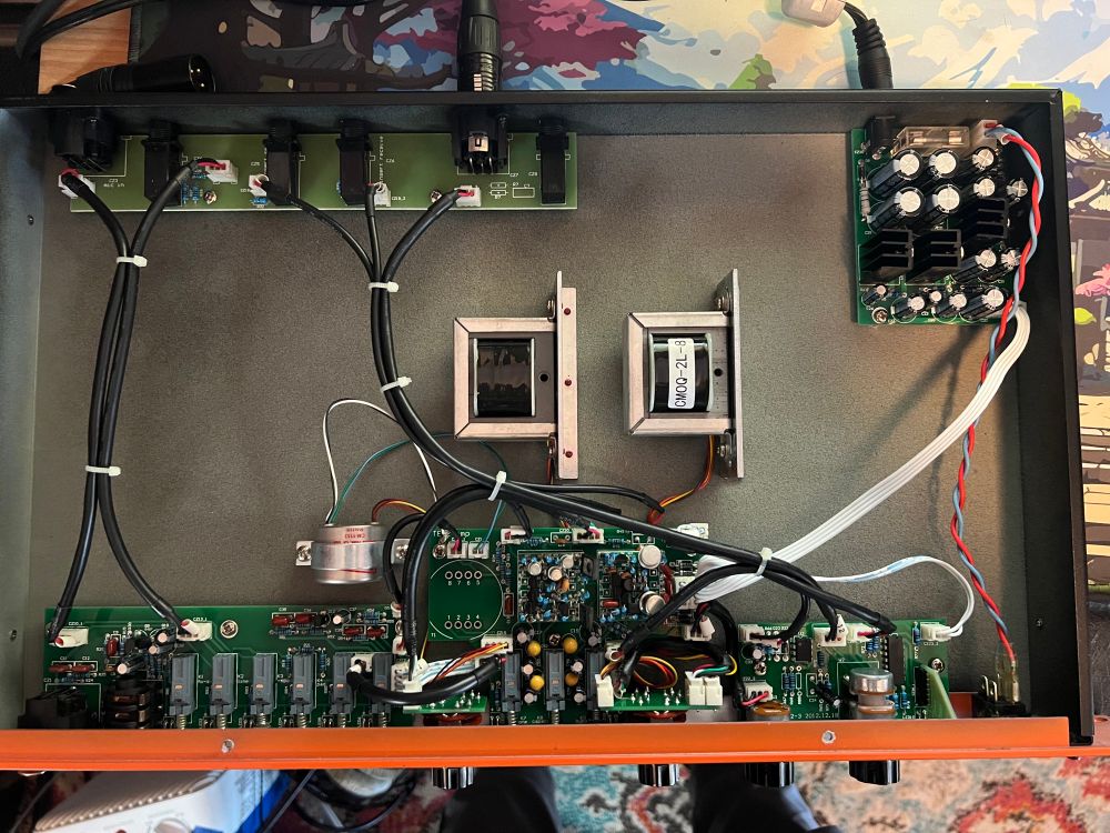 an overhead view of the TB-12. clockwise from top right to top left: the power board, output control board, tone controls with socketed op-amps, front input board, and rear input board. there are two input transformers and an output transformer present as well.