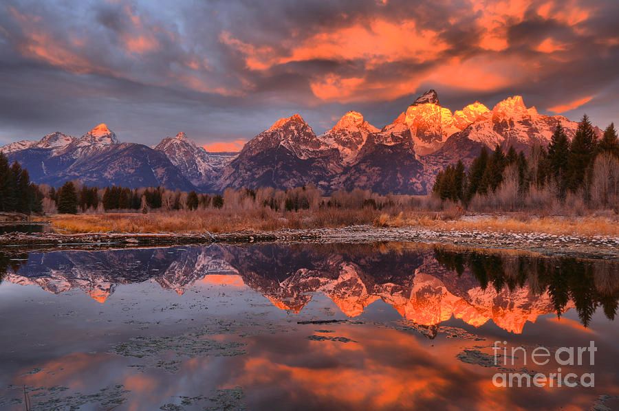 Morning autumn storm clouds hover over the Teton Mountain Range at Schwabacher Landing along the Snake River at Grand Teton National Park in Wyoming.  Photo by Adam Jewell.  Buy prints, puzzles, fleece blankets and more at AdamJewell.com
