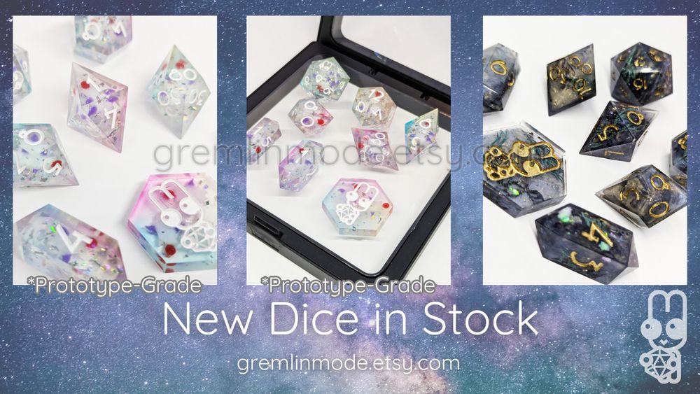 A simple collage of some hand-made dice sets, including two pastel moogle sets, and one dark, green, and gold set. It reads: "New Dice in Stock. gremlinmode.etsy.com" with "*Prototype-Grade" beneath both moogle dice pictures.