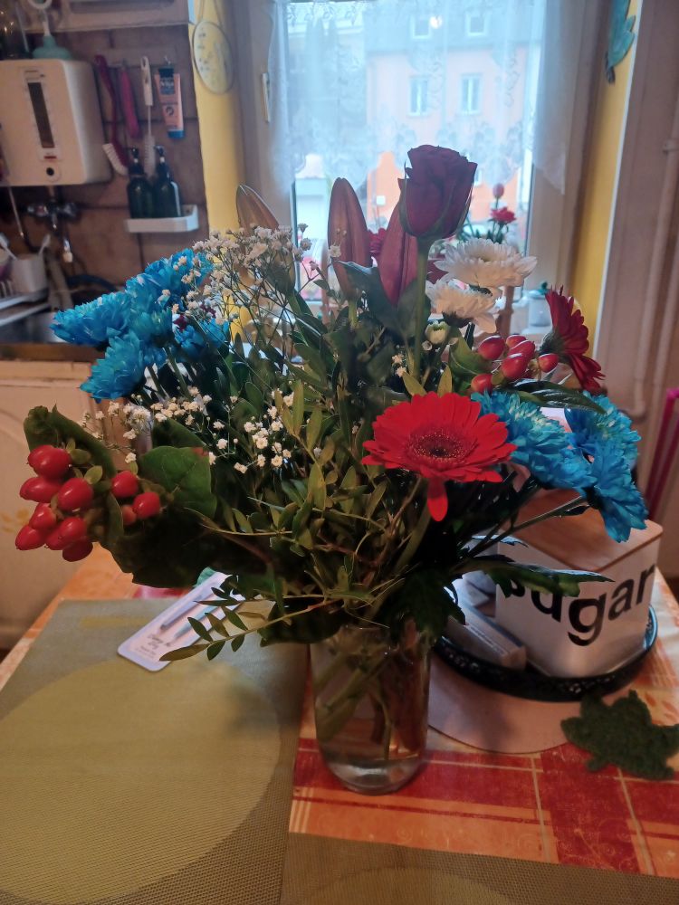 A flower bouquet comprised of various flowers in the colours of the Luxembourgish flag - red, white, and light blue. Issued to celebrate the ascension to the throne by Grand Duke Guillaume and Grand Duchess Stéphanie.