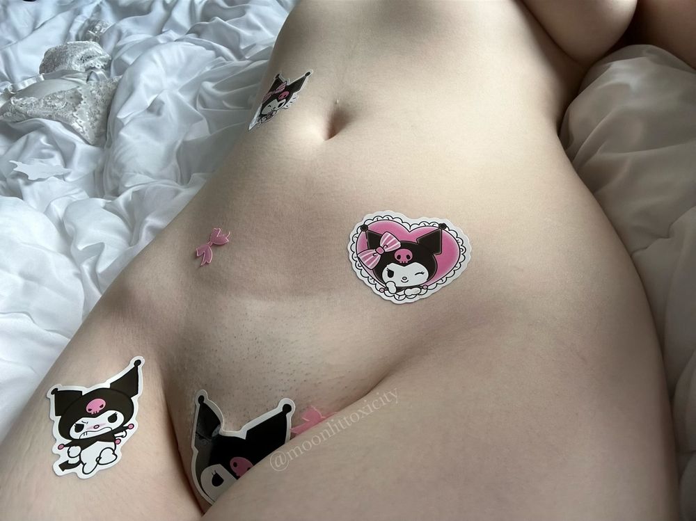 Someone’s lower abdomen and hips adorned in Sanrio Kuromi stickers and tiny pink bows.