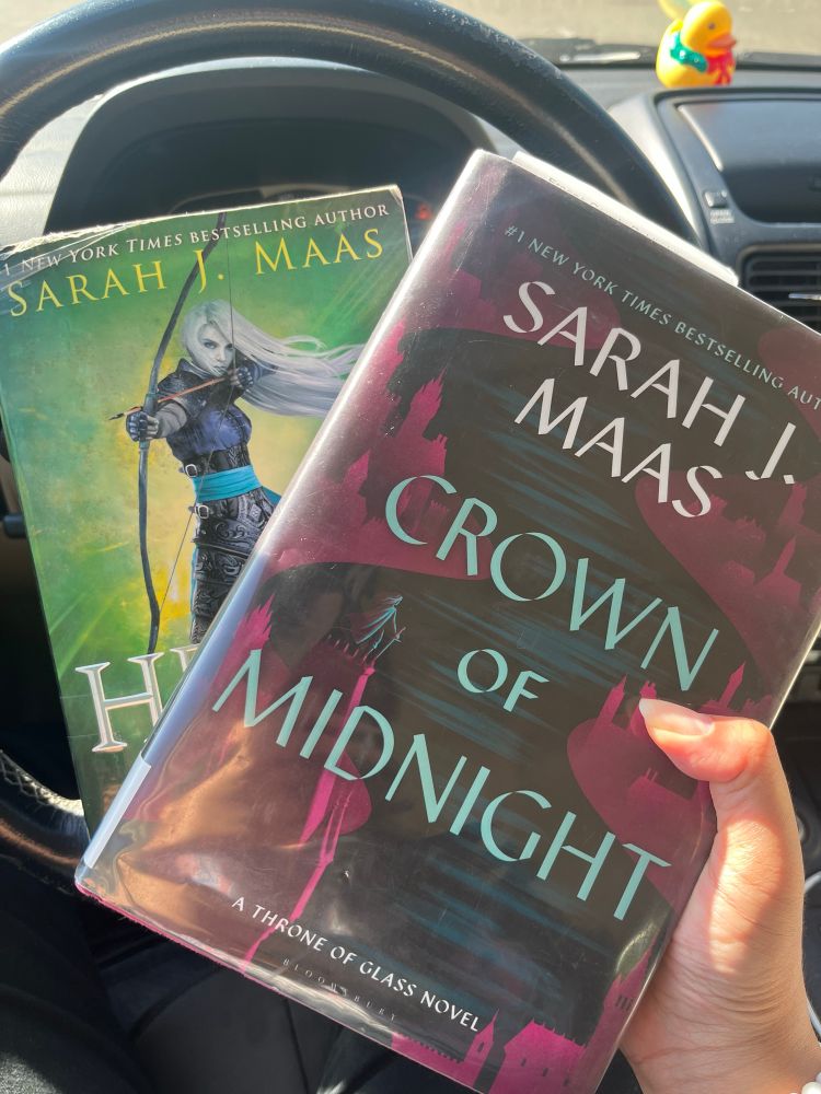 Potato holds a copy of Crown of Midnight & Heir of Fire in her hands 