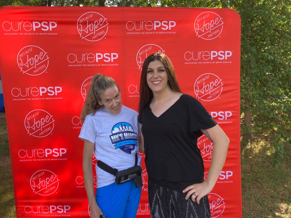 Former U.S. Rep. Jennifer Wexton and Virginia state Senator Danica Roem pose in front of a CurePSP banner.