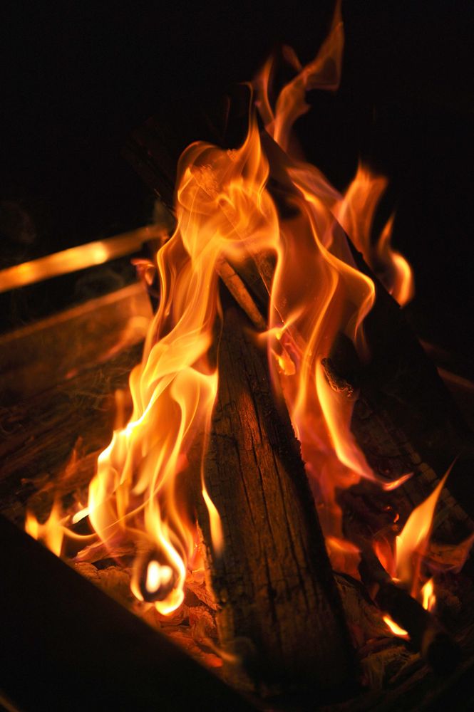 A photograph of a fire. The flames look like a fluid. 