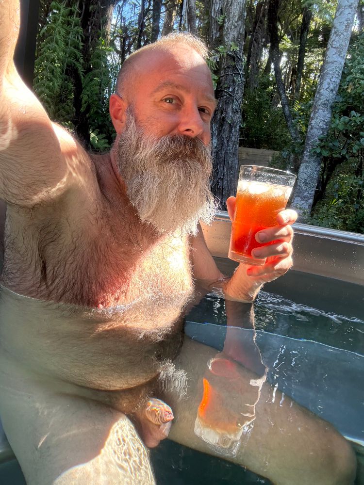 Growler and terrifyingly luminescent cocktail in the hot tub. 