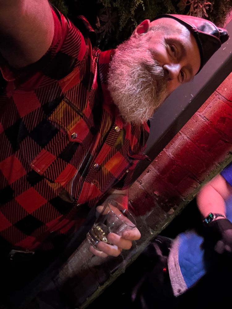 Growler in red leather shirt with whisky. 