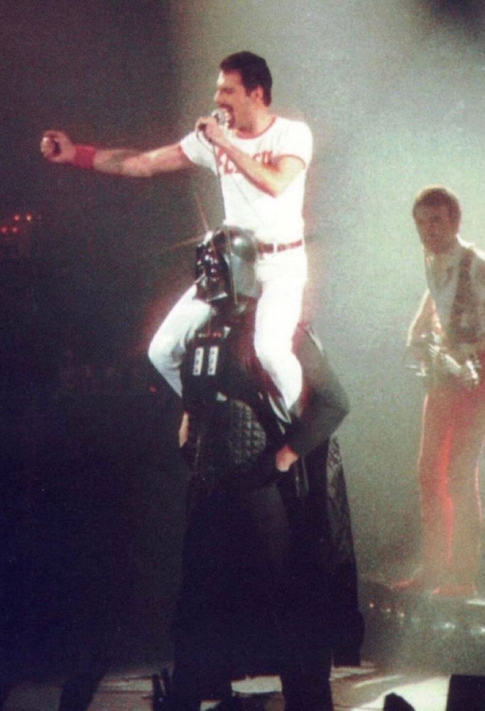 Freddie Mercury sitting on Darth Vader’s shoulders at the Death Star Christmas party, 1979
