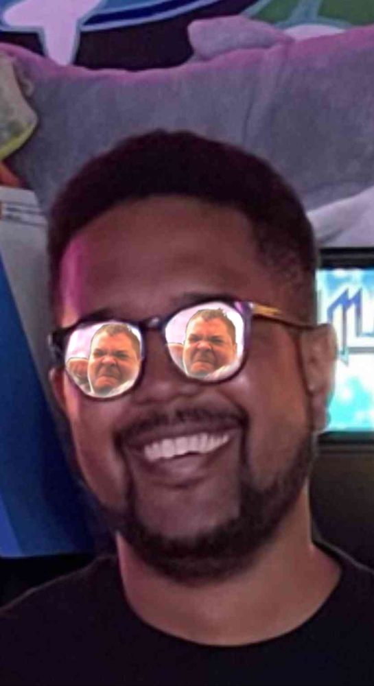 A commissioned picture of a friend. His glasses have a reflection of Majin Obama about to to punch him in the face while also having a white glare while he's smiling.