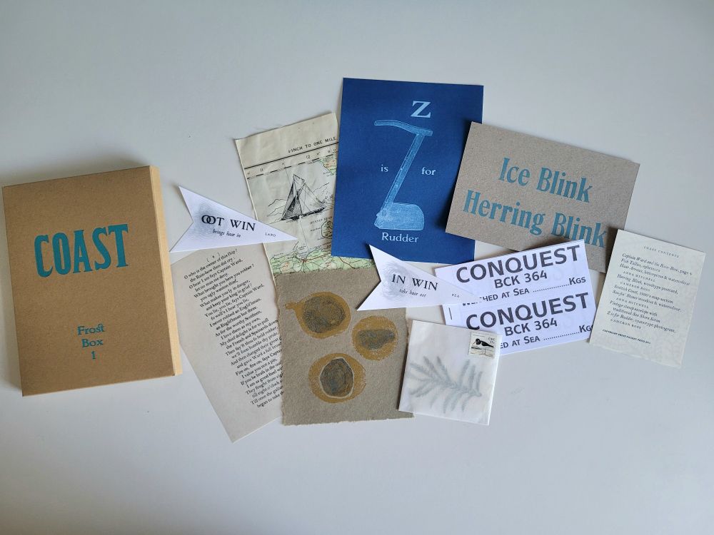 Contents of Coast Box, page of chapbook, haar arrows, vintage map section, cyanotype with rudder, woodcut print, fish tallies, letterpress Postcard and envelope with pressed leaf and bird stamp