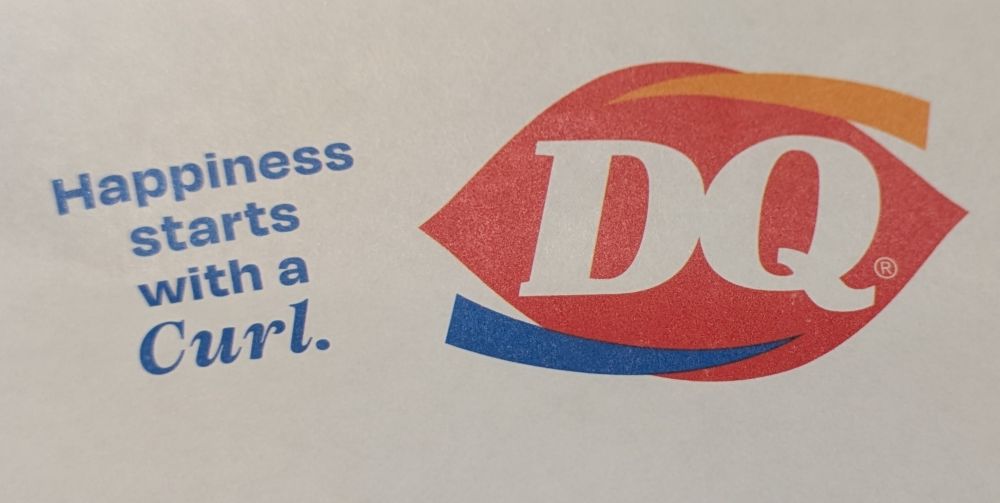 Text on the left says: 
"Happiness starts with a Curl." 
The Dairy Queen logo is on the left.