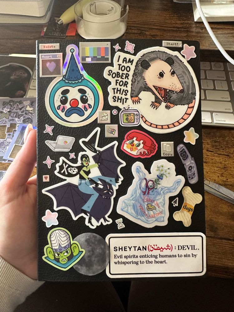 A black B6 planner covered in stickers.