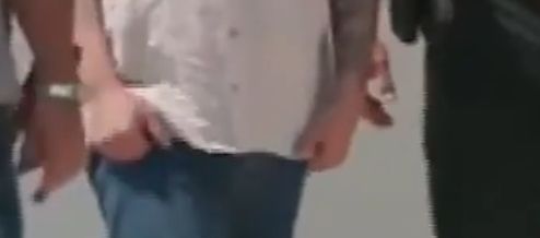 A screenshot of the video of Garcia being released from prison showing his knuckles without any tattoos evident.