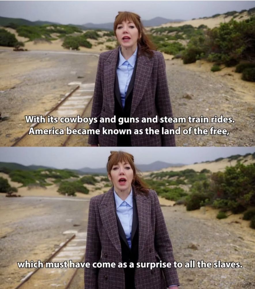 2 screenshots from a scene with Philomena #Cunk standing along a railroad track. Caption of first: "With its cowboys and guns and steam train rides, America became known as the land of the free." Caption of second: "...which must have come as a surprise to all the slaves."