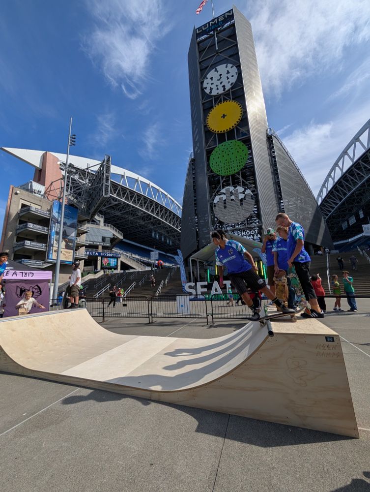 Some skaters standing on the mini ramp at the demo.