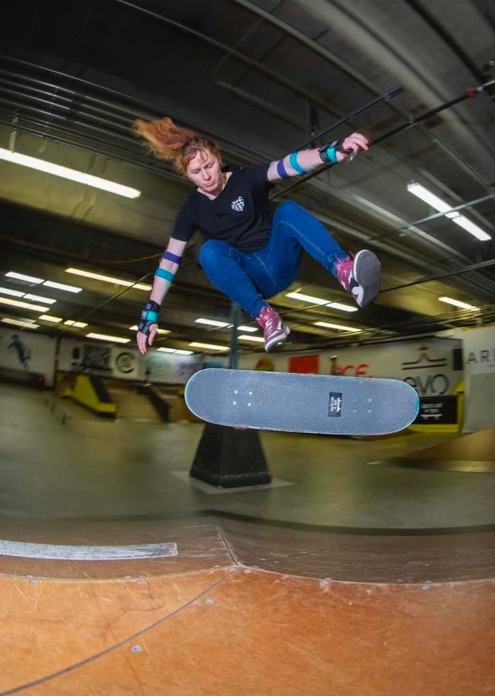 Myself doing a backside flip over a hip at the All Together skatepark.