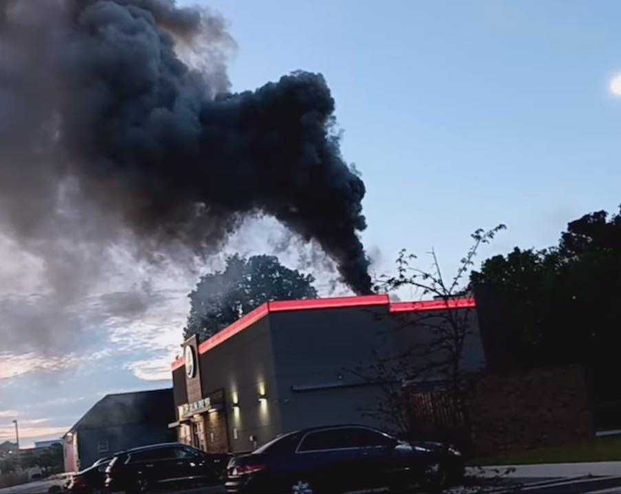 A Burger King with black smoke billowing out of the roof
